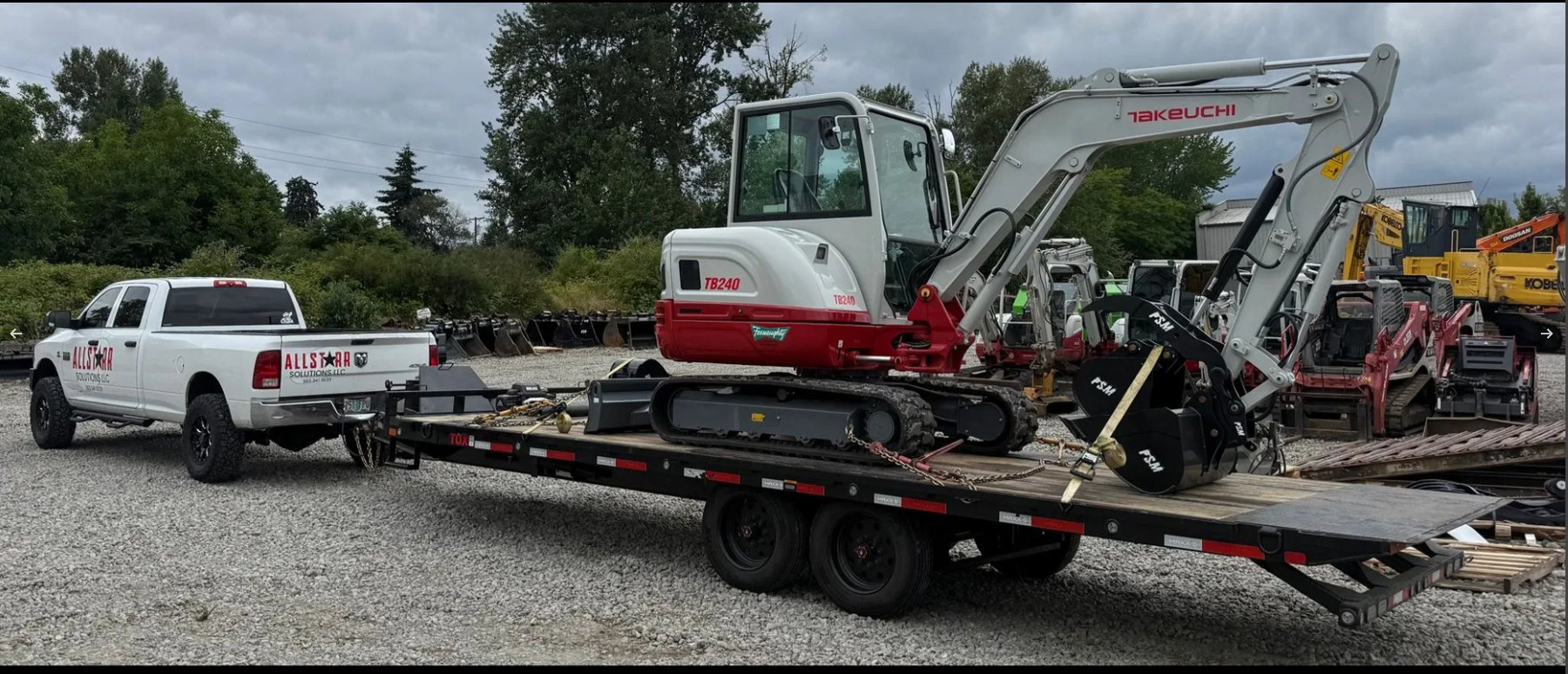 Excavator loaded on a trailer for a heavy junk removal job