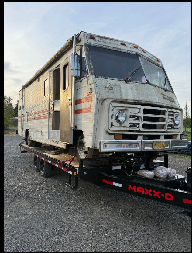 Motorhome loaded onto a heavy-duty removal trailer